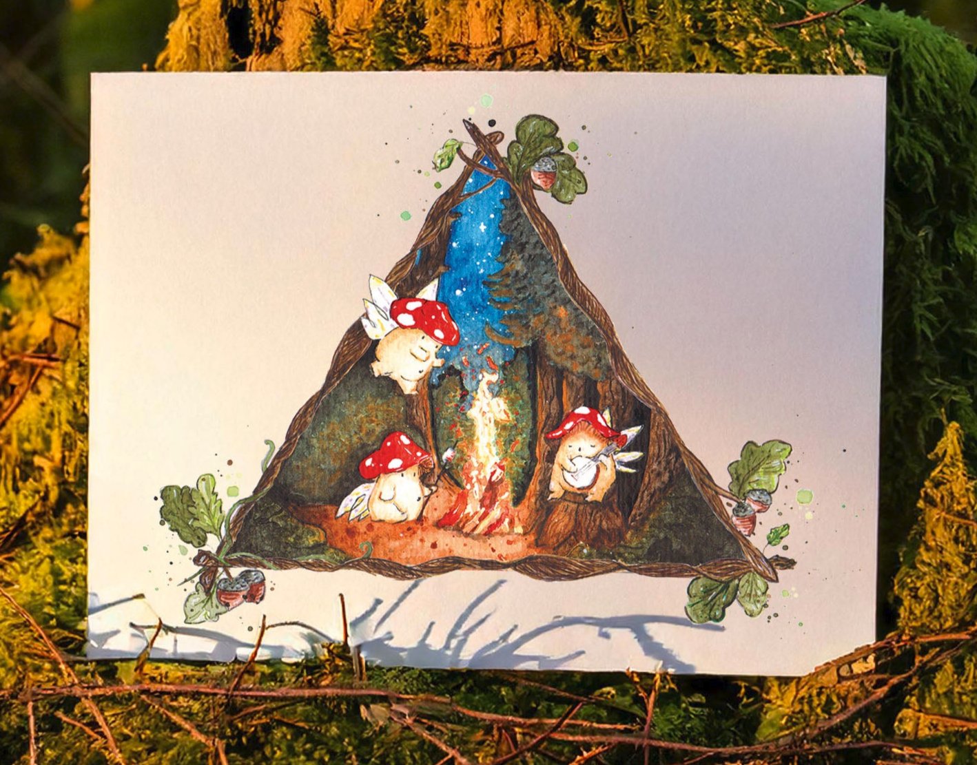 high quality art print placed on an autumnal forest floor, showing three toadstool mushroom fairies around a glowing campfire within a dark forest
the scene is framed within a triangle of vines and branches with acorns and leaves at each point