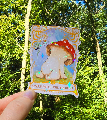 a holographic vinyl sticker with away with the fairies written on it underneath artwork of a toadstool mushroom meeting a fairy who is offering it a daisy