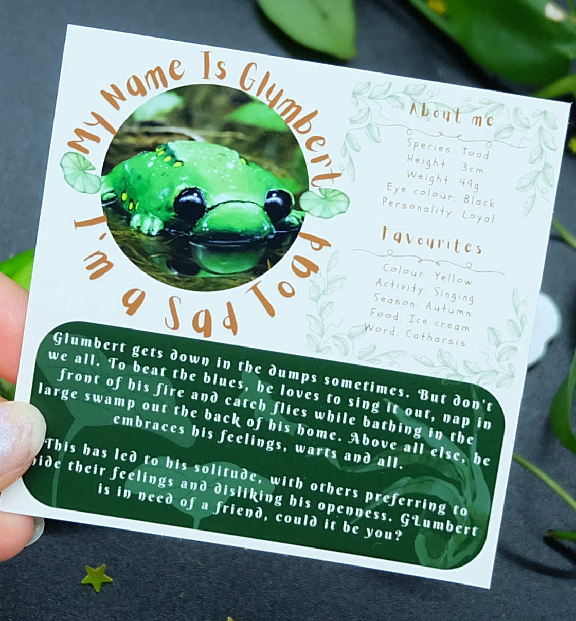 character card about glumbert the toad a miserable toad / frog who lives in a forest. 