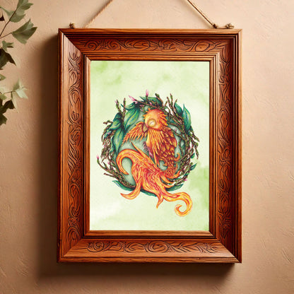 image shows a portrait art print featuring a painting of a baby phoenix resting on it's side, inside a nest made of twigs, leaves and budding flowers. behind the main detail of the painting, there is a green watercolour wash making the background mottled green. it is placed inside a carved wooden frame  which is hanging against a light terracotta venetian plaster wall, and to the left the leaves of a plant creep into the corner of the frame 
