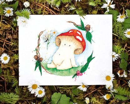 An art print lays on a woodland floor surrounded by daisies. The water colour illustration is of a toadstool mushroom meeting a fairy. the fairy is offering a daisy