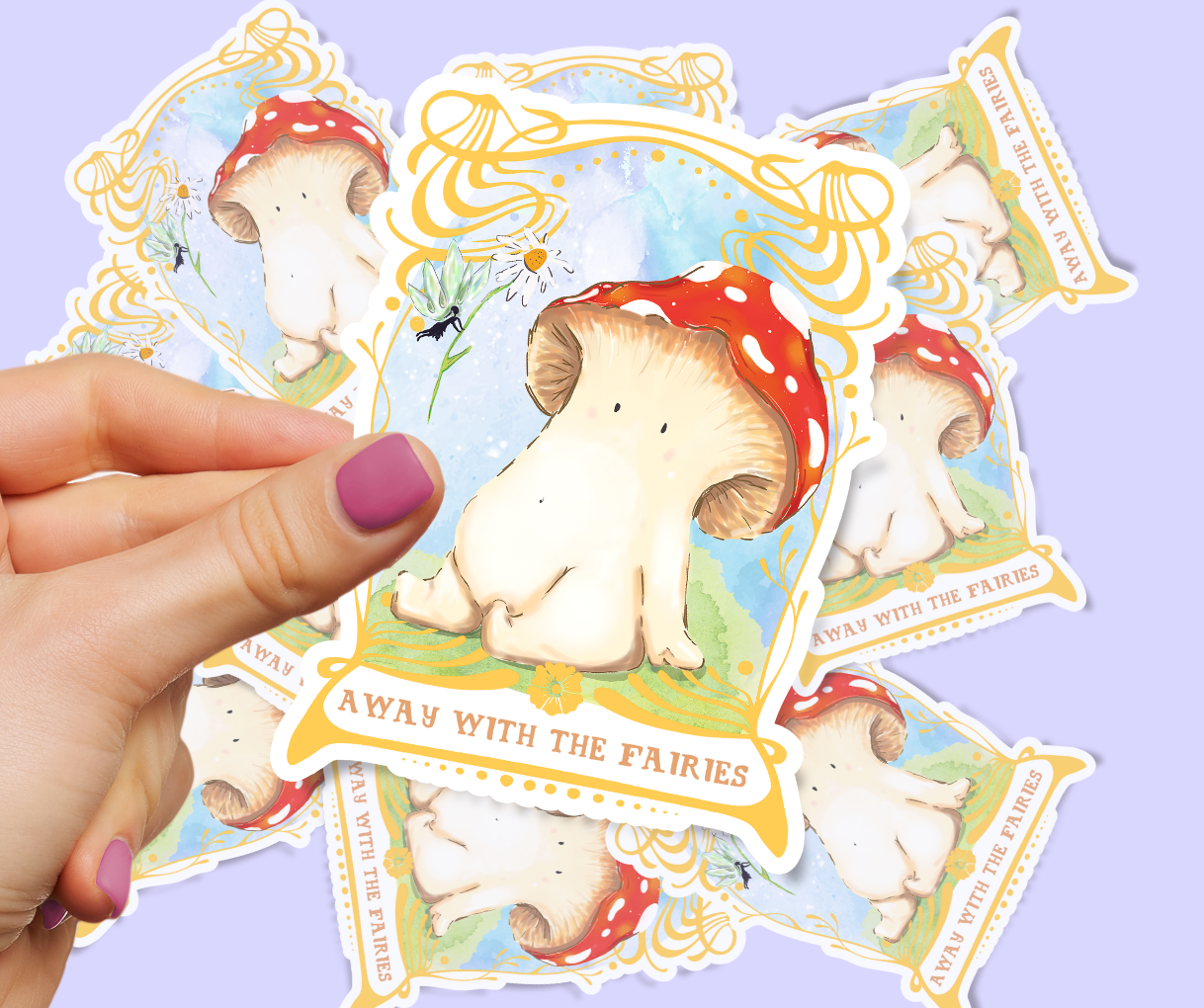 Image shows sticker of toadstool mushroom seated on a bed of mossy grass, they are looking up at a fairy who is handing them a daisy from above. The artwork is framed by an ornate gold art nouveau style frame. the sticker is held by two fingers in front of a pastel lilac background which has the same sticker scattered in a pile beneath